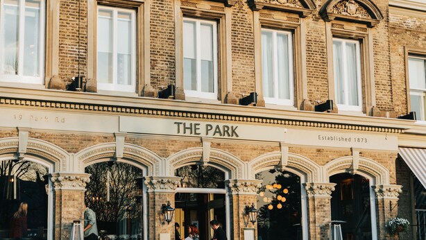 A historic building with a sign reading "The Park Established 1873" at the entrance.