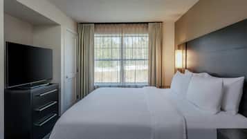 Premium bedding, desk, laptop workspace, blackout curtains