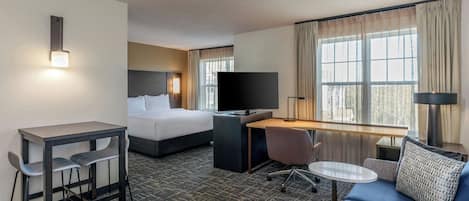 Premium bedding, desk, laptop workspace, blackout drapes