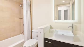 Ein modernes Badezimmer mit Badewanne, Toilette und Waschtisch.