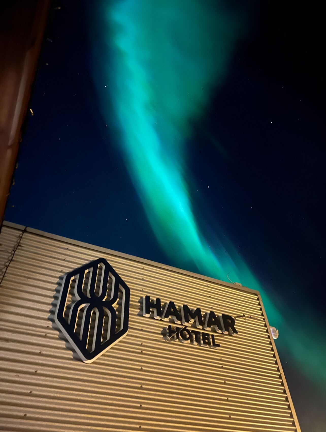 A hotel sign with the name "HAMAR HOTEL" and a distinctive logo.