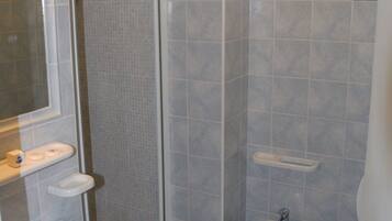 Un baño con ducha, lavabo y bidé.