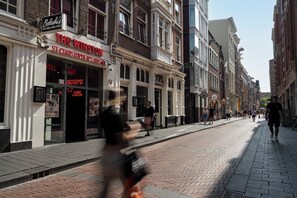 A street view with a hotel named "The Winston St Christopher's House" featuring a bar, live music, and hard liquor. - St Christopher's at The Winston - Hostel (Amsterdam)