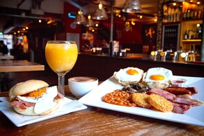 A breakfast plate with eggs, bacon, beans, and toast. - St Christopher's at The Winston - Hostel (Amsterdam)