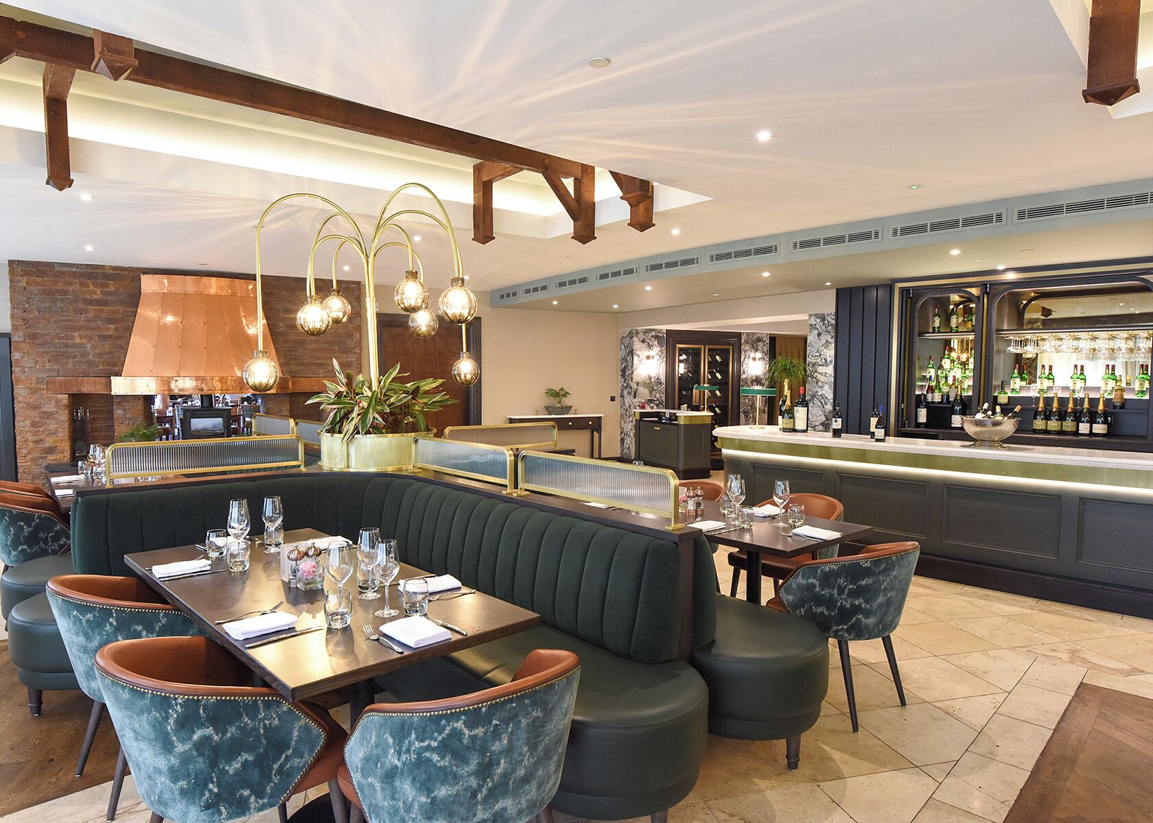 Ein Restaurant mit Barbereich, Sitzecken und einer Bar mit Flaschen.