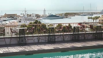 Outdoor pool, open 10 AM to 8 PM, pool umbrellas, pool loungers