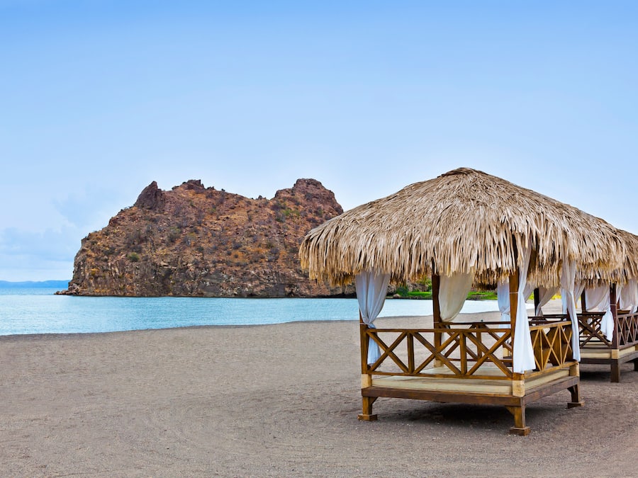 En la playa, sillas reclinables de playa, sombrillas