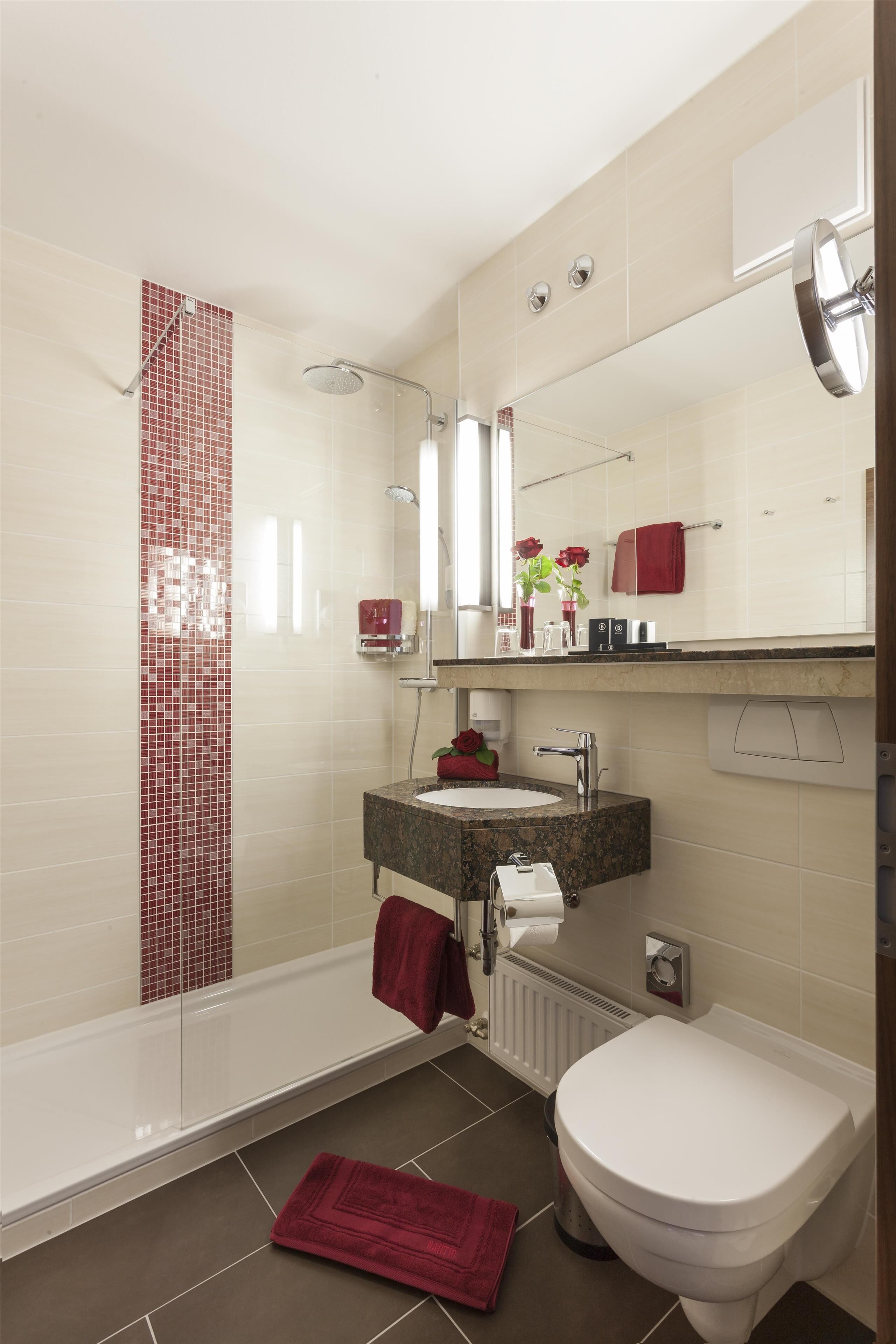 A modern bathroom with a bathtub, a toilet, and a sink.
