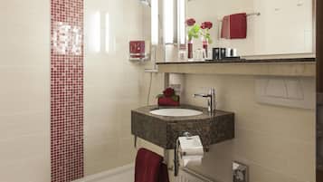 A modern bathroom with a bathtub, a toilet, and a sink.