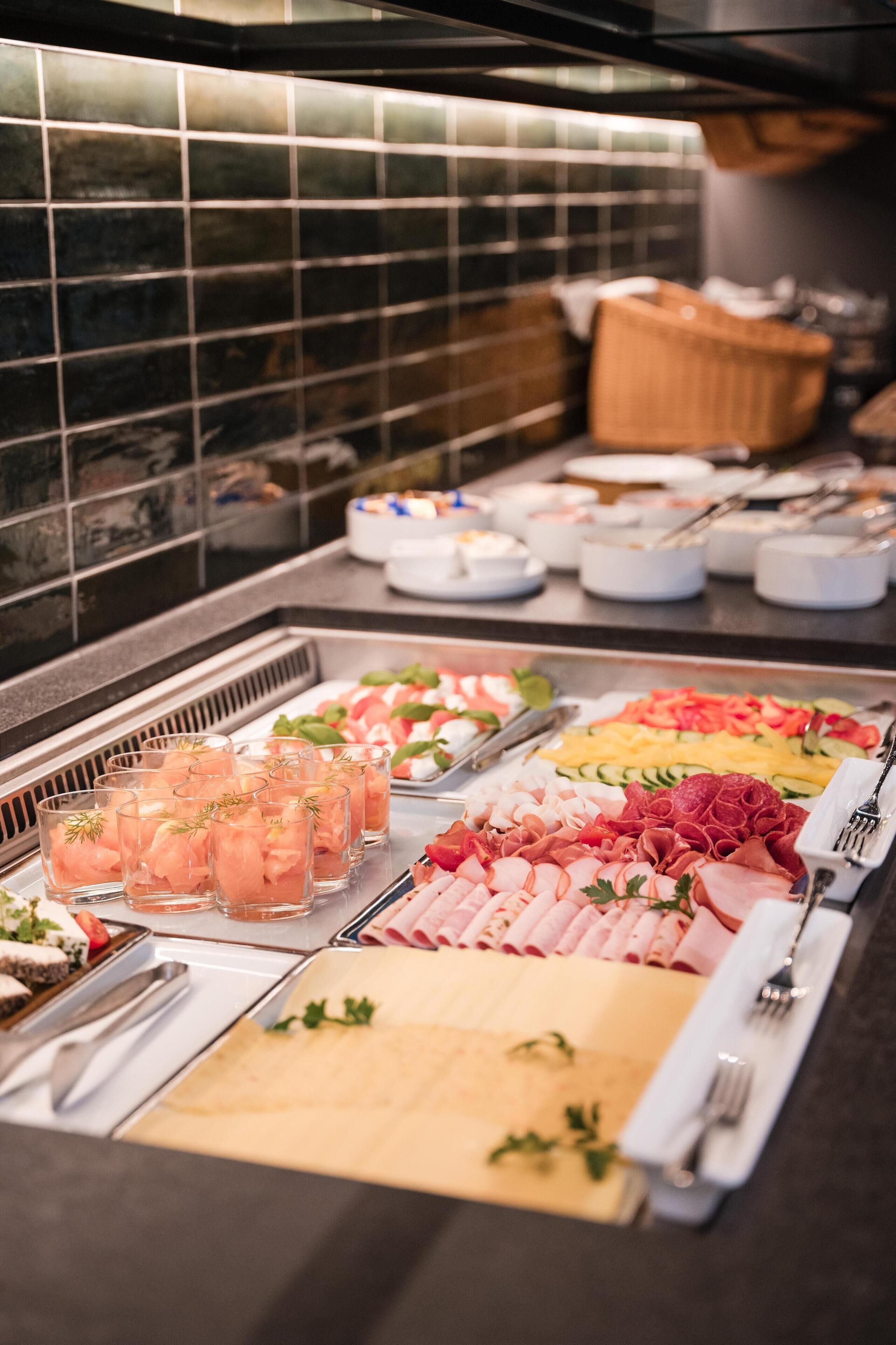 A buffet with various food options and drinks.
