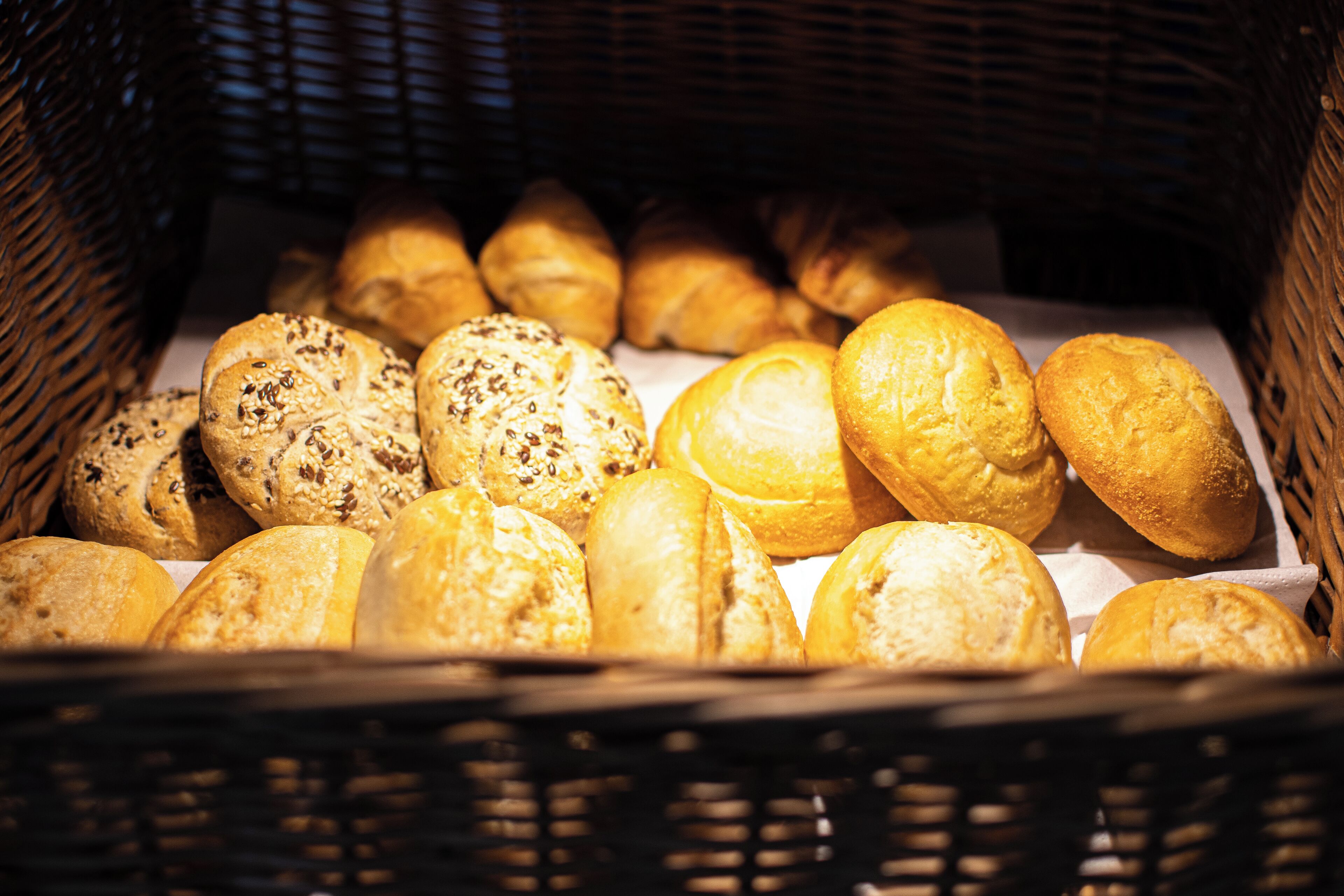 A basket filled with various types of bread.