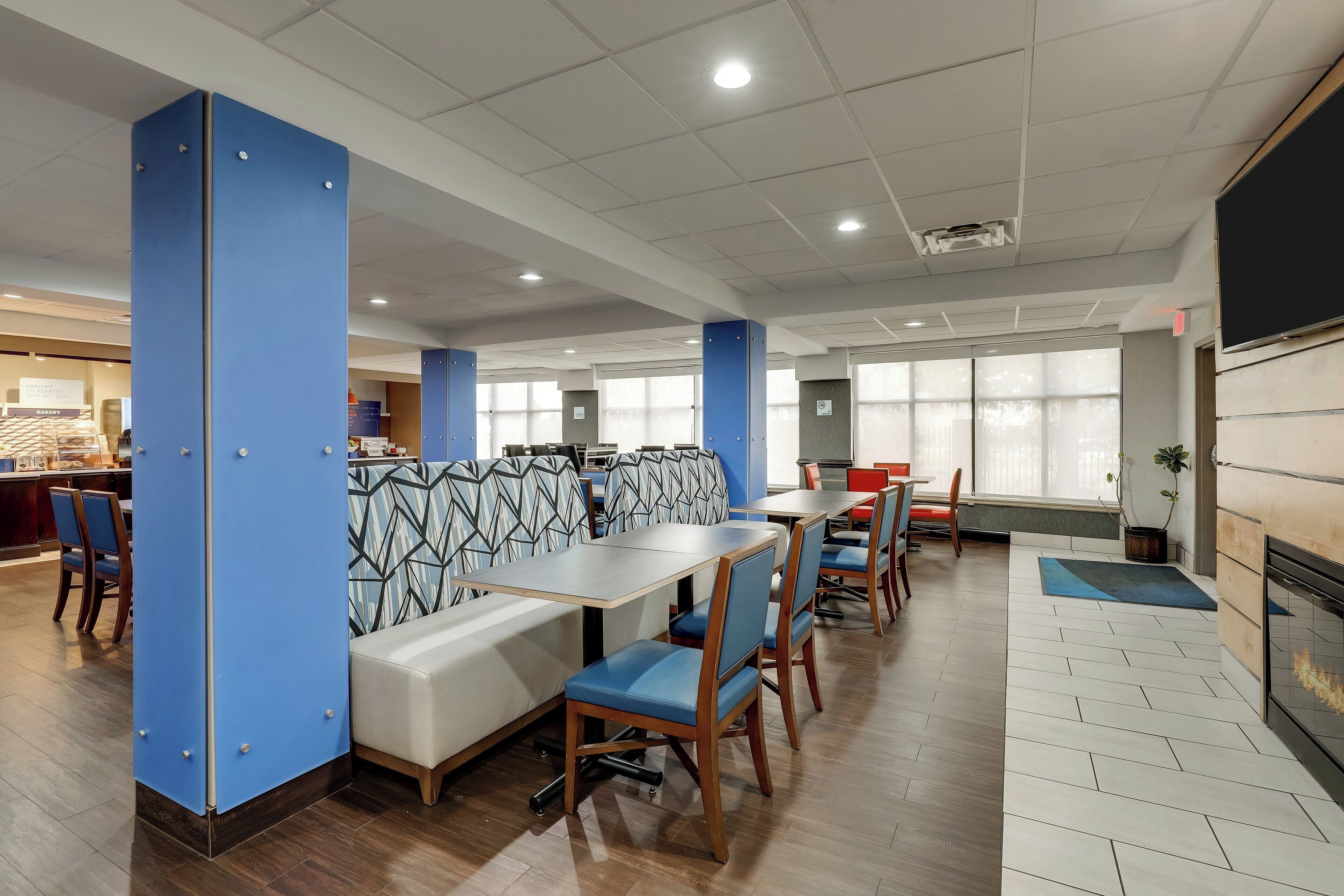 A modern dining area with booths, tables, and chairs.