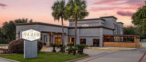 The Angler Hotel with a modern design, a landscaped front yard, and a restaurant area.