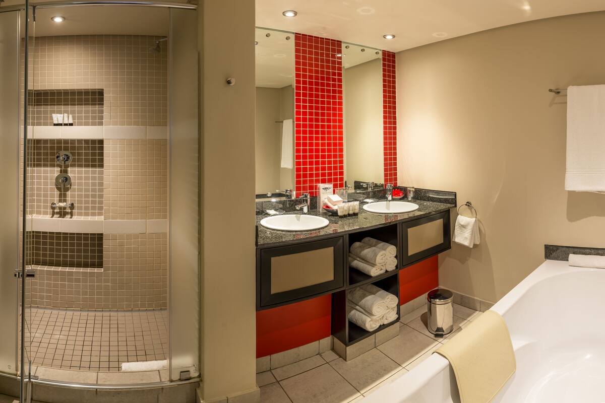 separate bathtub and shower, designer toiletries, hair dryer, towels