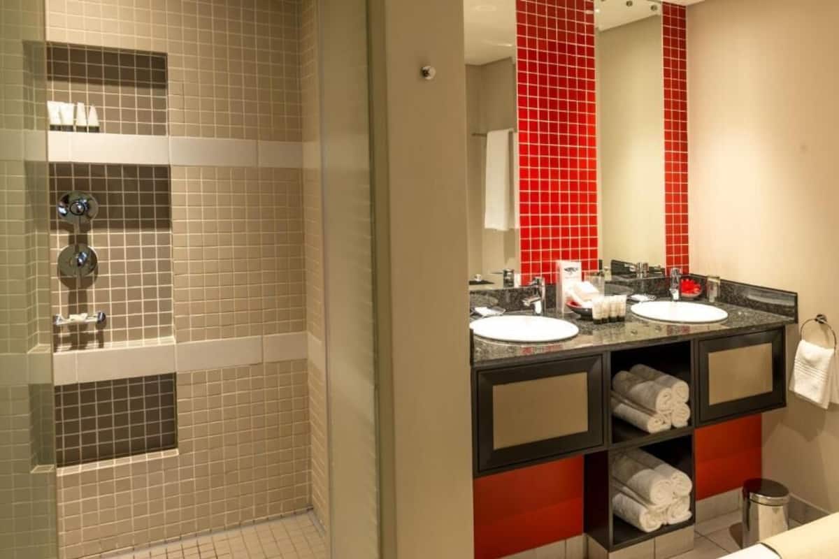 superior twin room | bathroom | separate bathtub and shower, designer toiletries, hair dryer, towels