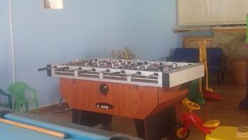 Enjoy games and fun in this recreational room with a foosball table and pool table.