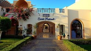 A building with a sign reading "Souk Makadi" and an arched entrance. - JAZ Makadi Saraya Resort - All inclusive (Makadi Bay)