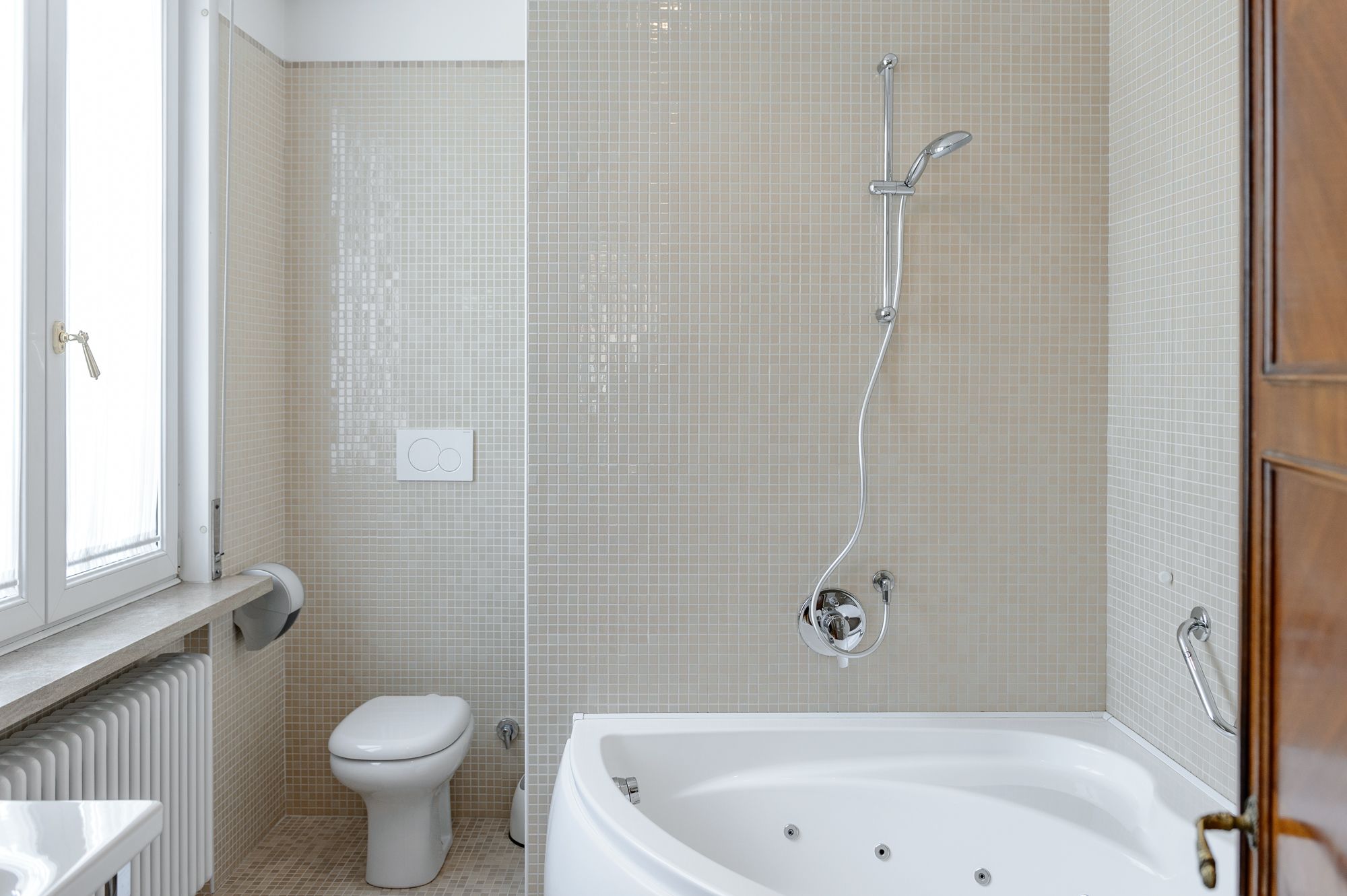 A bathroom with a bathtub, toilet, and shower.