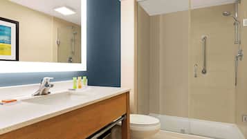 A modern bathroom with a shower, toilet, and sink.
