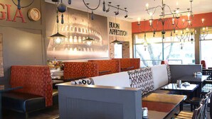 A restaurant interior with booths, tables, and a large illuminated sign. - Comfort Inn Fallsview (Niagara Falls)