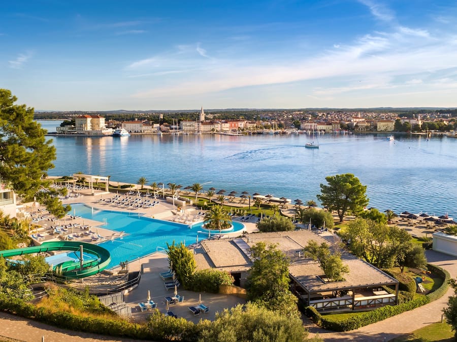 Una piscina techada, una piscina al aire libre de temporada, sombrillas