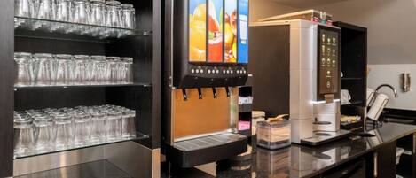 A beverage dispenser with multiple drink options, a glassware rack, and a coffee machine.
