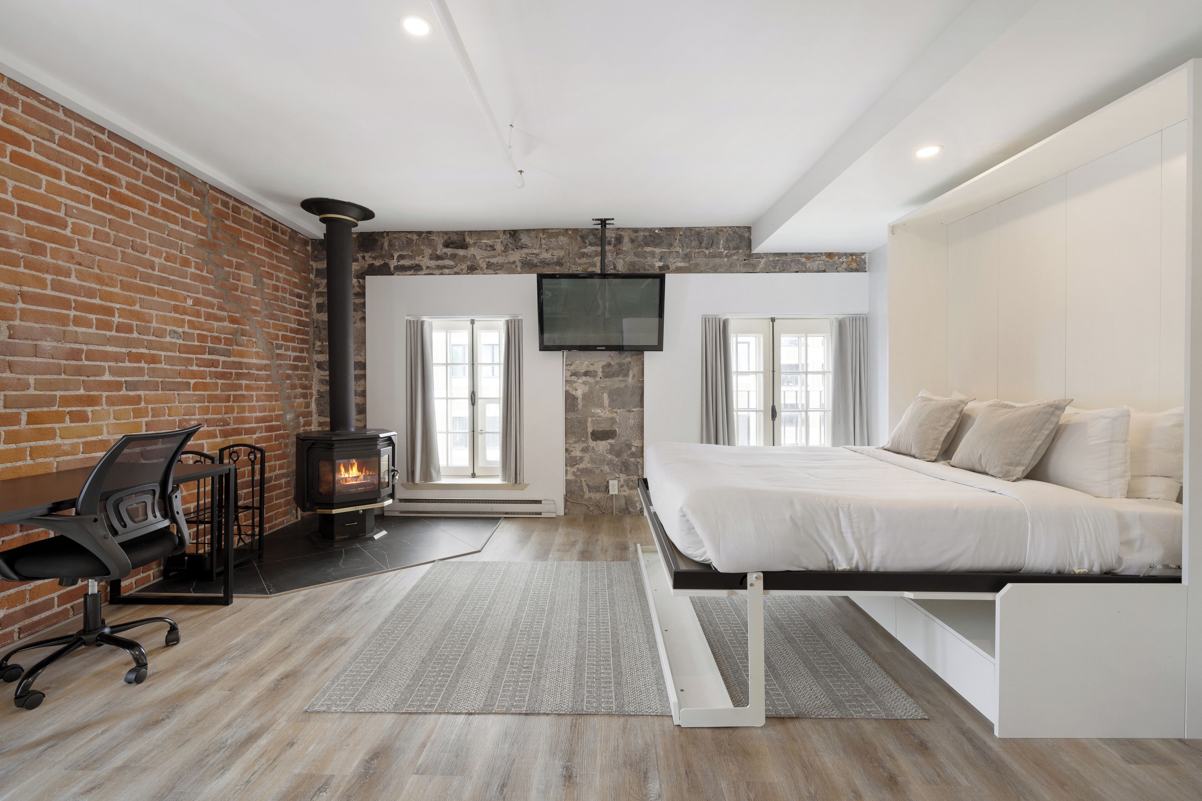 superior suite, 1 king bed with 1 queen murphy bed (no pet allowed) | living area | flat-screen tv, heated floors