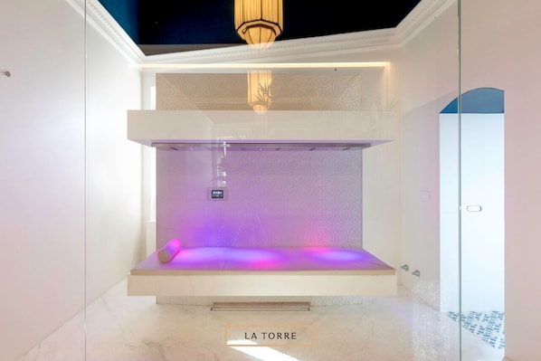 A modern spa room with a bench, a control panel, and a glass shower enclosure. - Sant'Angelo, Matera (Matera)