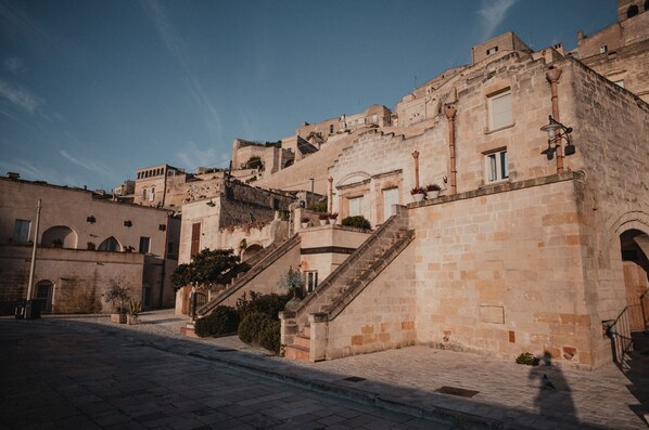 A historic stone building with a staircase leading to an upper level.