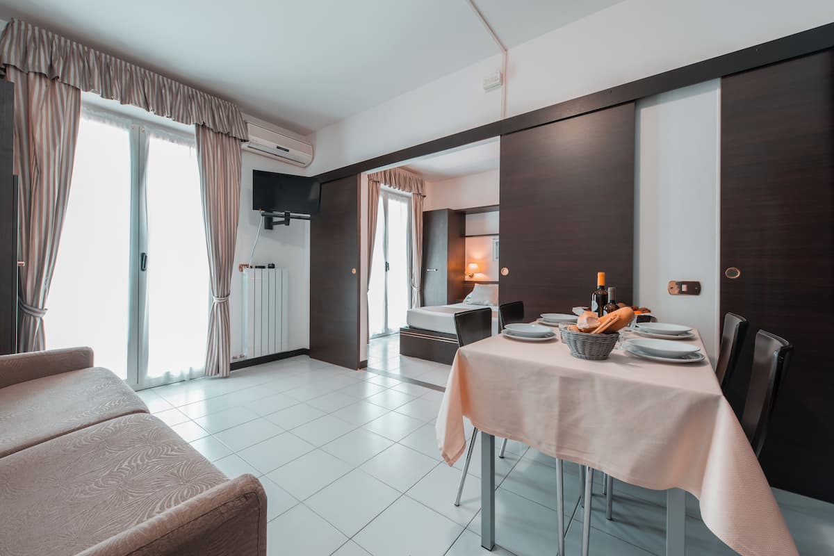 Standard Apartment, 1 Bedroom | Living area | 32-inch TV with digital channels