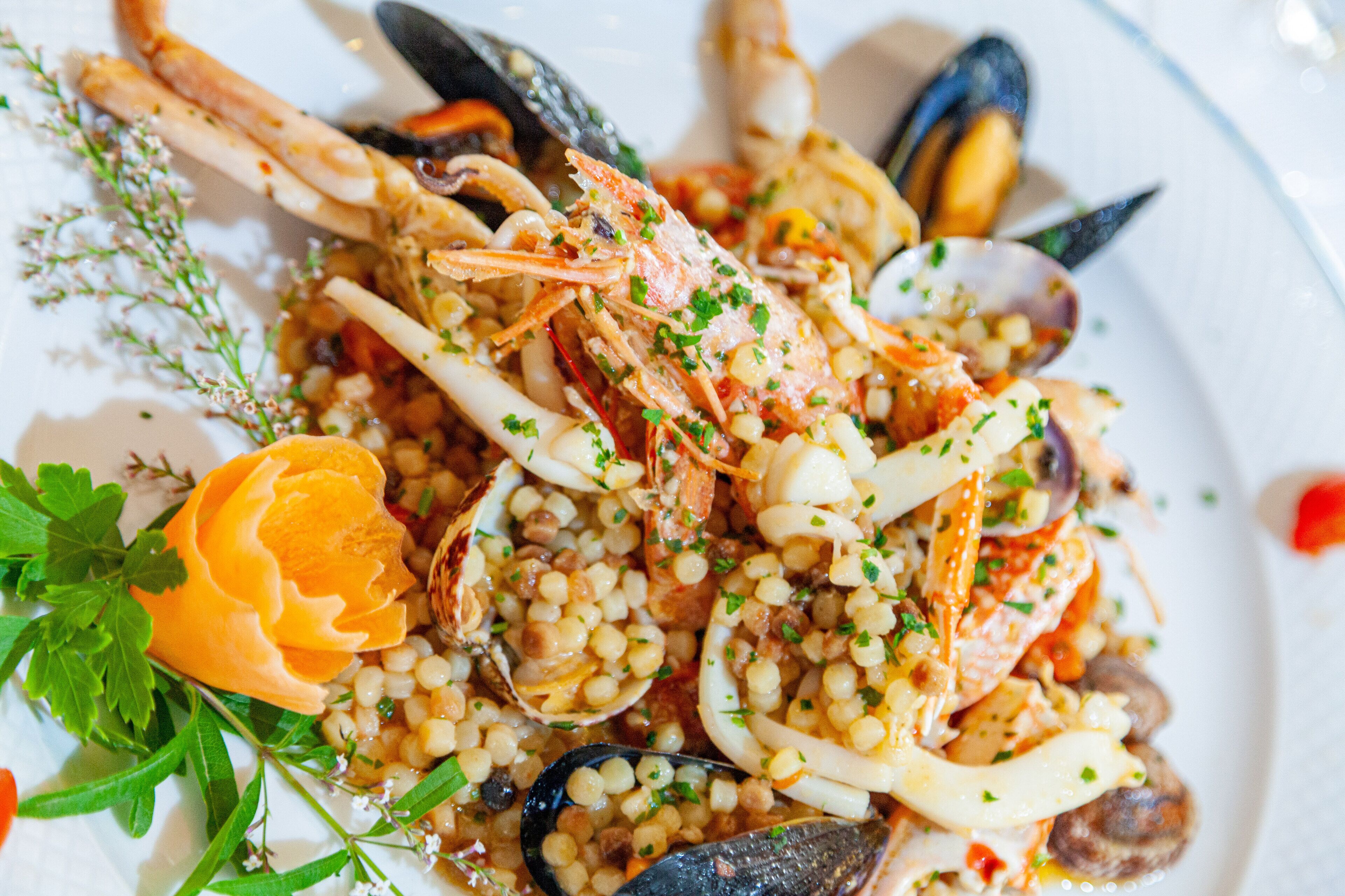 A seafood dish with mussels, shrimp, and corn on a plate.