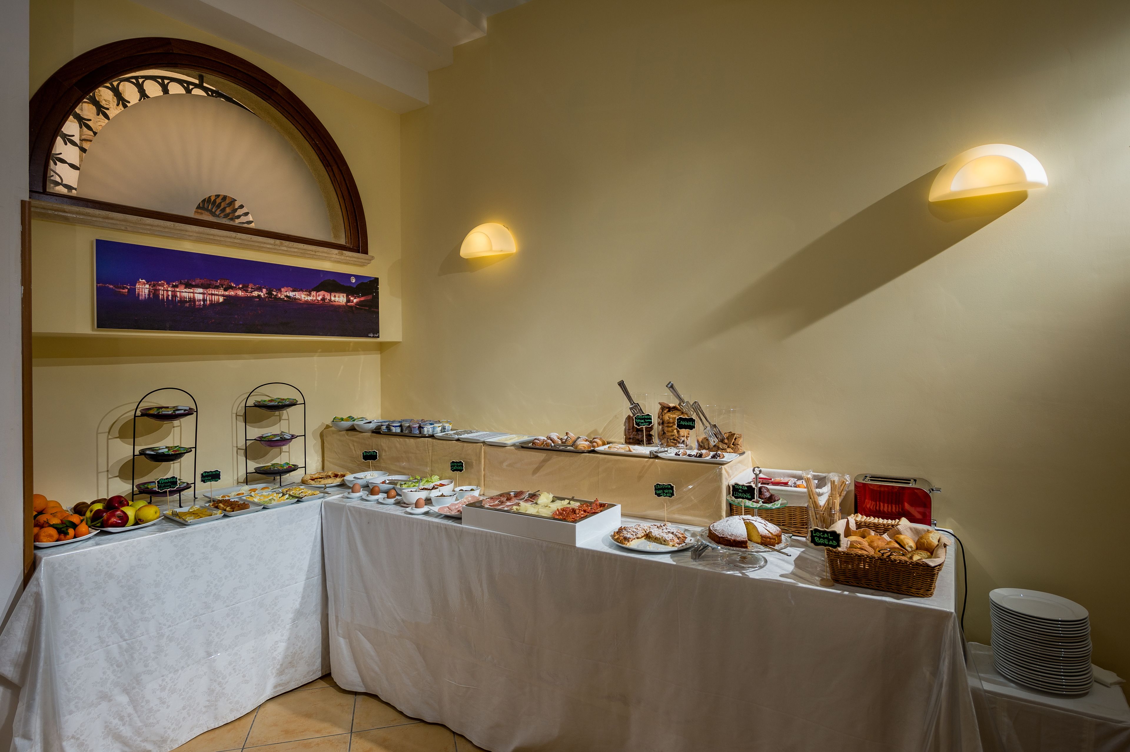A buffet setup with various food items and a scenic view in the background.