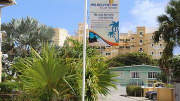 A banner advertising Melbourne Inn & Car Rentals with contact information and a website URL.