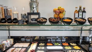 A breakfast buffet with various food items and condiments.
