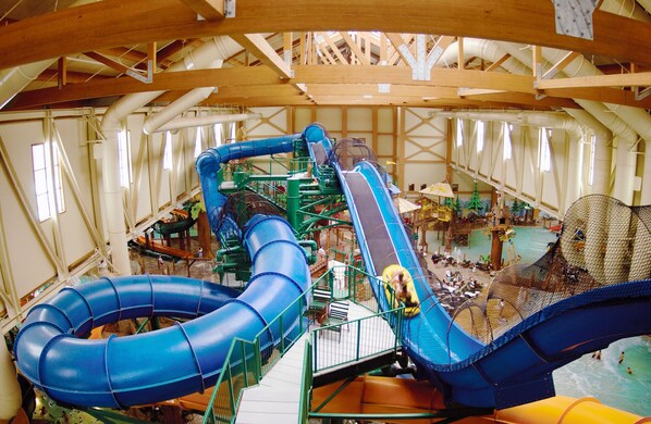 An indoor water park with multiple slides and pools.