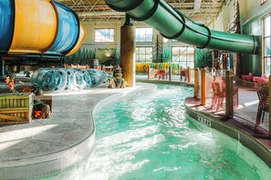 A water park with a large indoor pool, slides, and seating areas. - Great Wolf Lodge Niagara Falls (Niagara Falls)