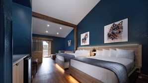 A bedroom with two beds, a wooden floor, and artwork on the walls. - Great Wolf Lodge Niagara Falls (Niagara Falls)