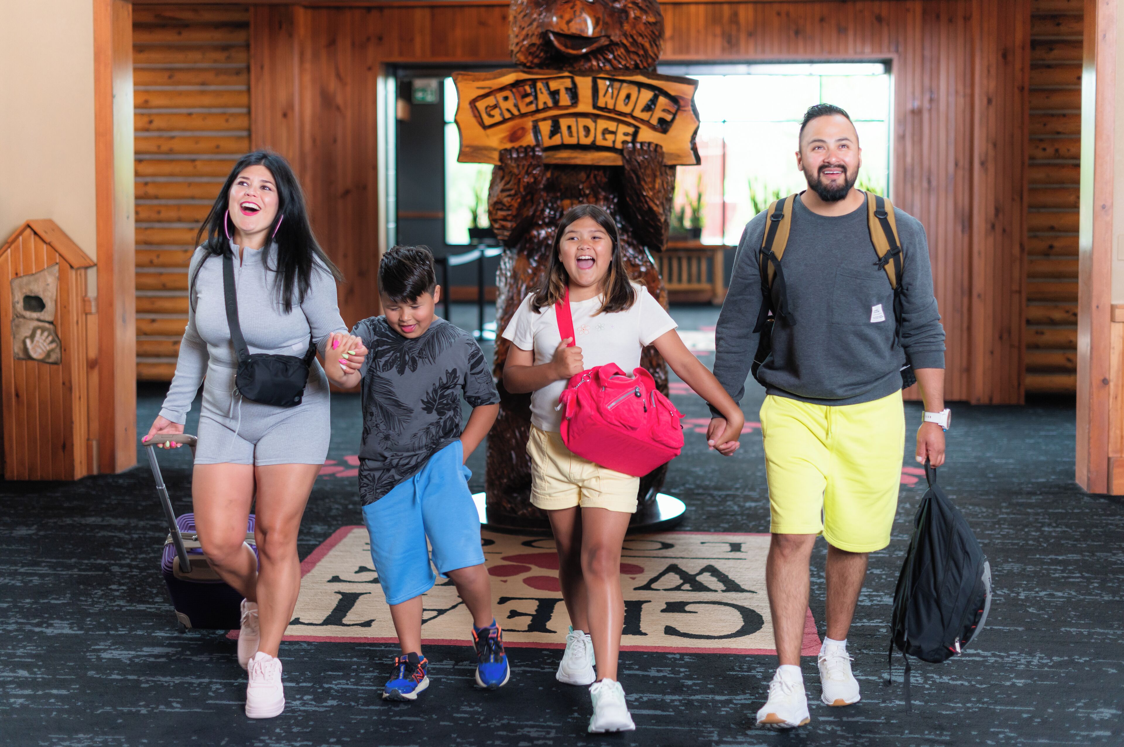 A family of four at the Great Wolf Lodge entrance.