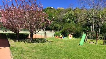 Enjoy a family-friendly atmosphere with a playground, playhouse, and lush green surroundings.
