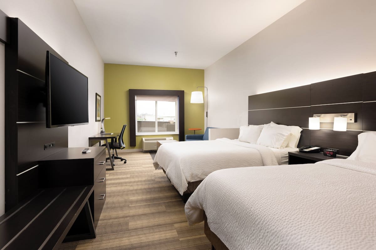 Two single beds, flat-screen TV, and desk with chair.