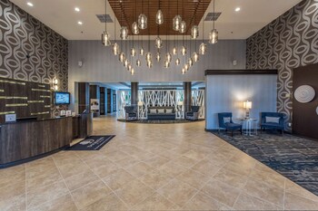 Relax in style with a comfortable seating area and modern reception desk. at DoubleTree by Hilton North Charleston - Convention Center