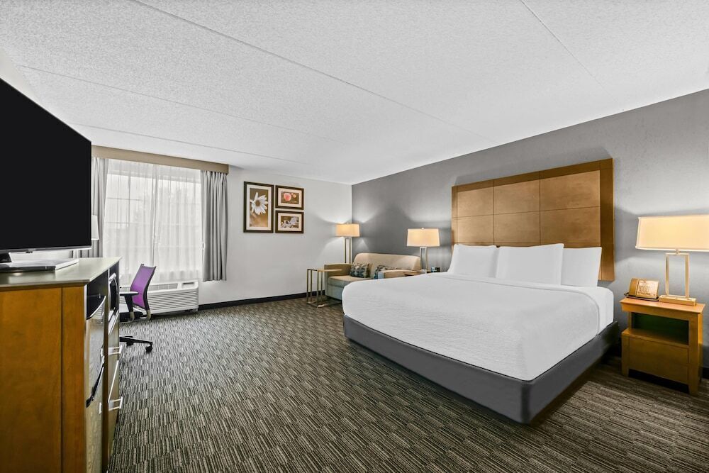 Premium bedding, desk, laptop workspace, iron/ironing board