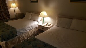 A hotel room with two beds, a bedside table with a lamp, and a telephone. - The Brooke Hotel (Brookshire)
