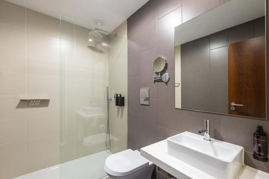 shower, rainfall showerhead, hair dryer, towels