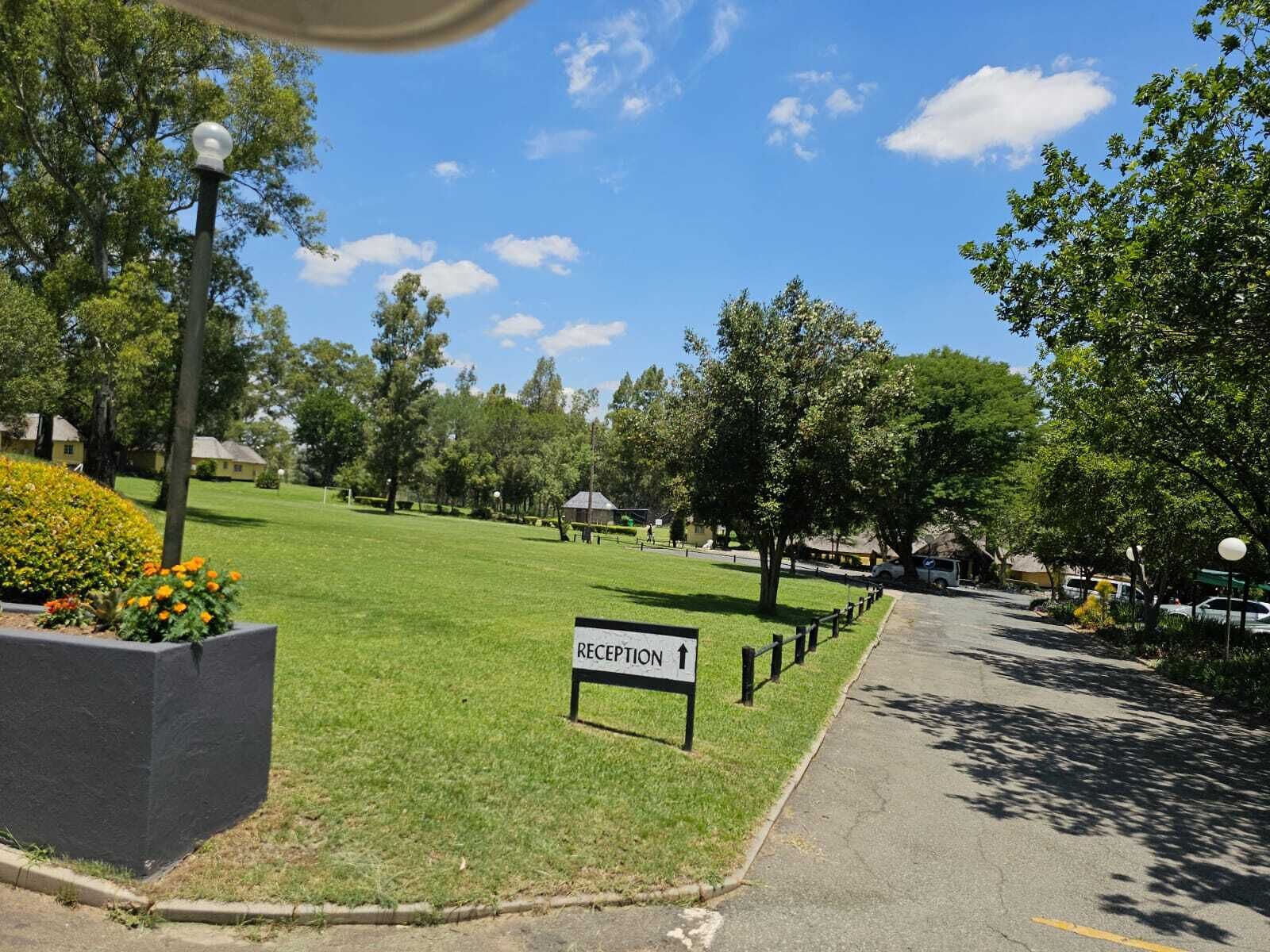 A reception area with a sign indicating the direction to the reception.