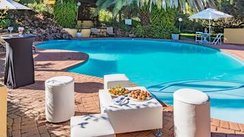 Alberca al aire libre y sombrillas en la alberca