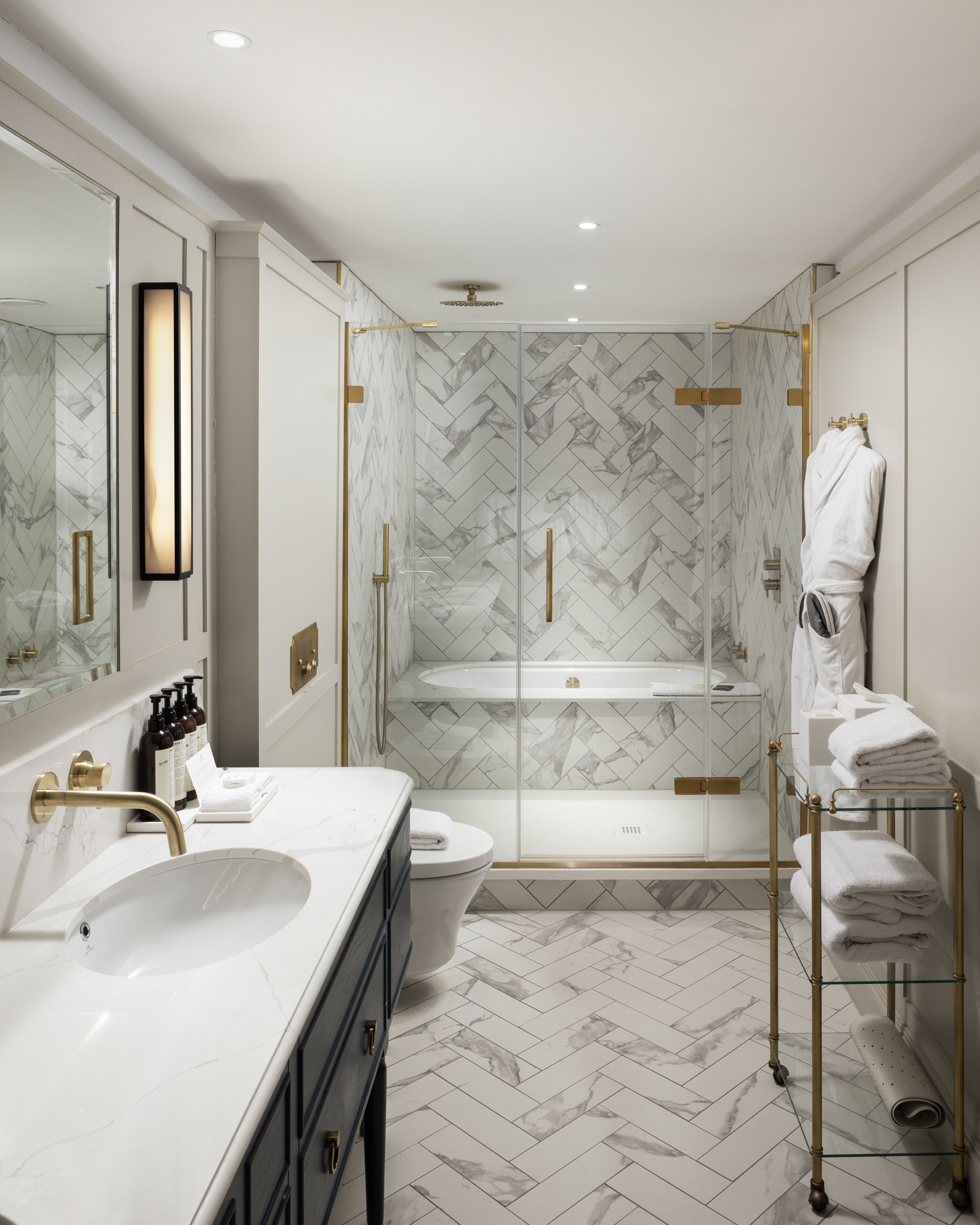 house deluxe stateroom | bathroom | separate bathtub and shower, designer toiletries, hair dryer, slippers