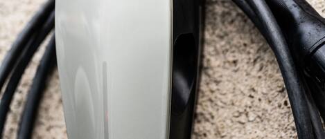 A Tesla charging station with a sign indicating it is for Tesla vehicles.