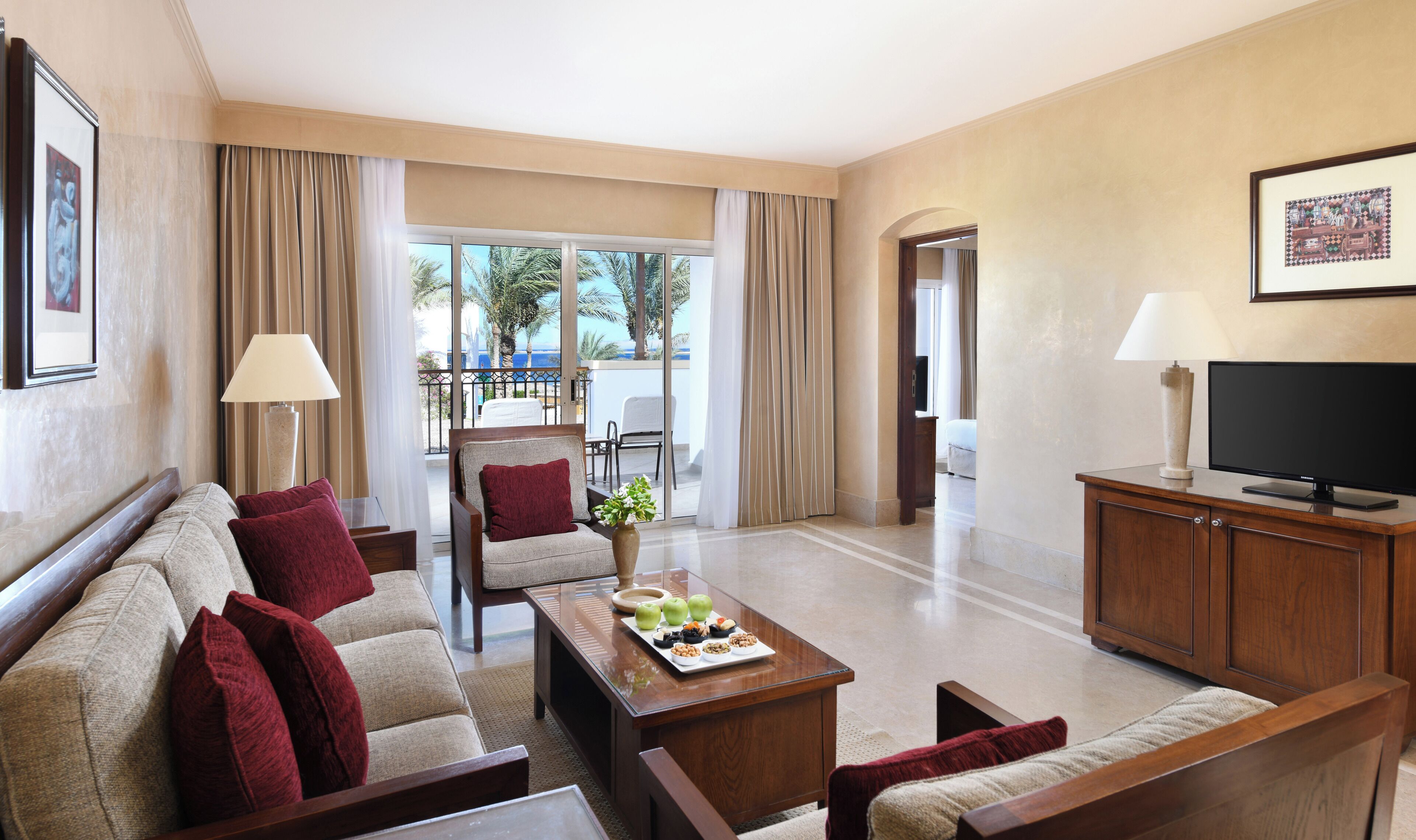 junior suite, 1 queen bed, sea view | living area | 32-inch lcd tv with satellite channels, tv