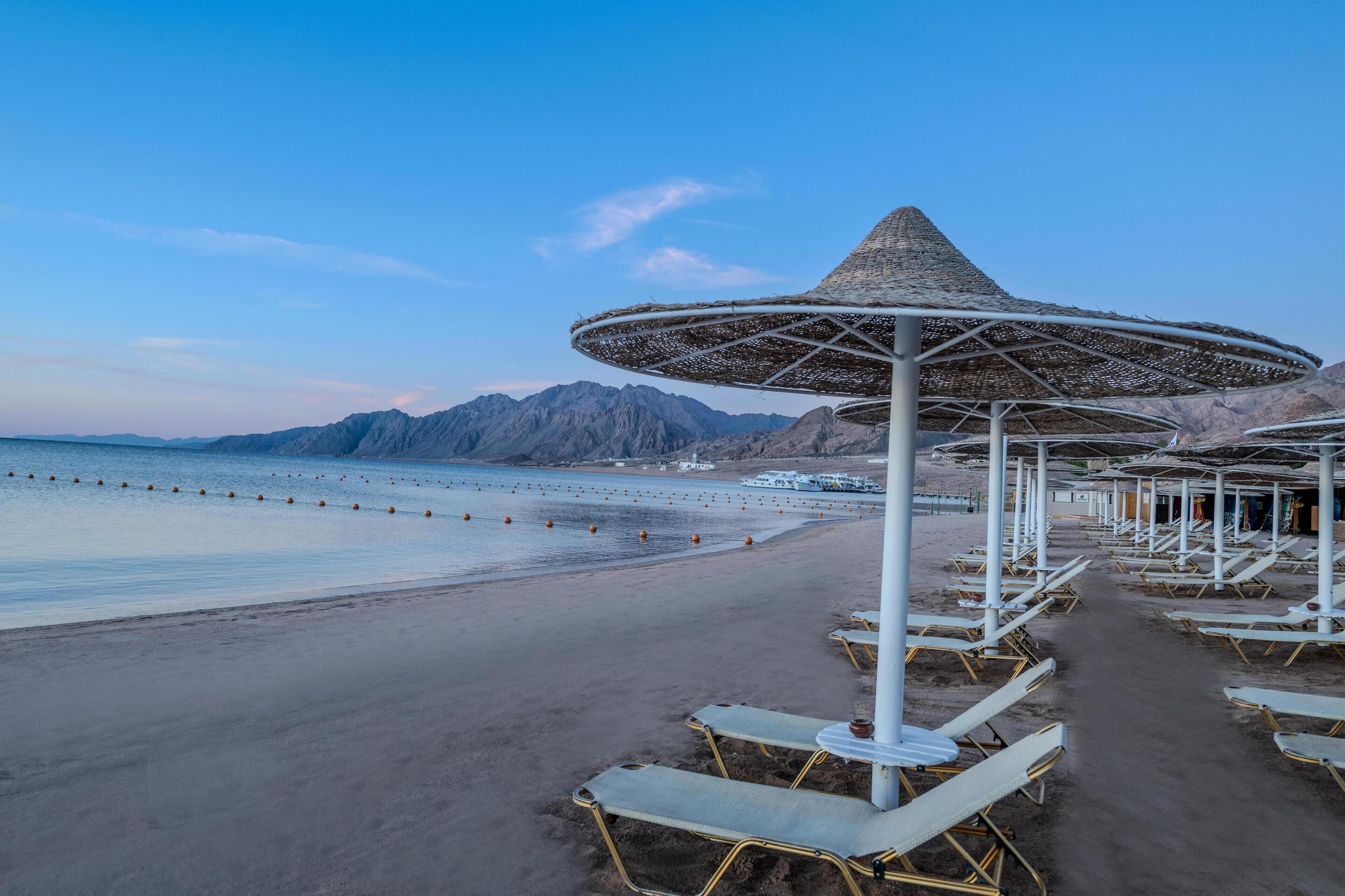 sun-loungers, beach umbrellas, beach towels, windsurfing